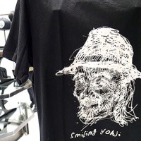 ドローイング調に山本耀司のポートレイトがプリントされたTシャツ