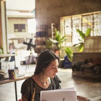 Artist Meryl Smith (USA) reviewing sketches in Cambodia