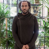 Portrait of Rashid Johnson, in front of his work Plateaus (2014) at Fondation Louis Vuitton, Paris (2017). ©Rashid Johnson. Photo credits: ©Fondation Louis Vuitton / Felix Cornu