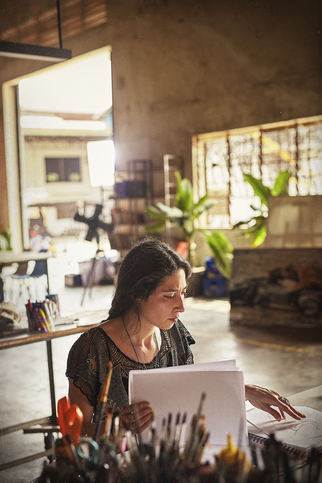 Artist Meryl Smith (USA) reviewing sketches in Cambodia